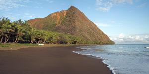 The dark sand beach at Ouroue camping